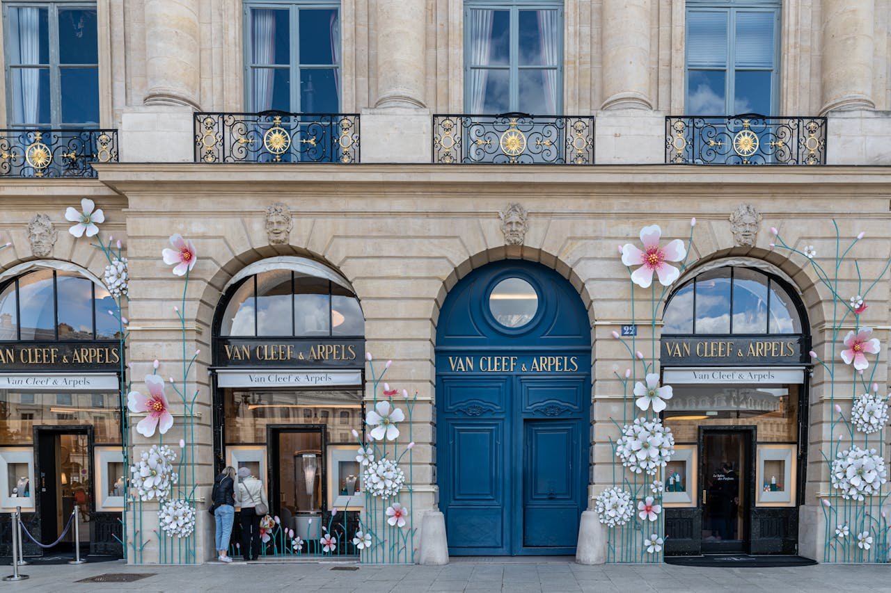 A building with flowers on the front and blue doors